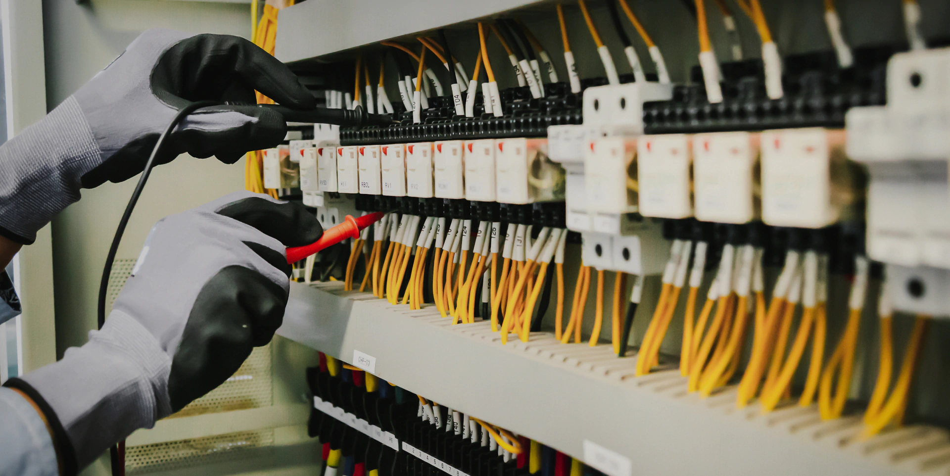 electrician checking the voltage of the electrical panel opt